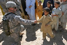 0420-0908-0418-3540_american_soldier_shaking_hands_with_an_iraqi_boy_m.jpg